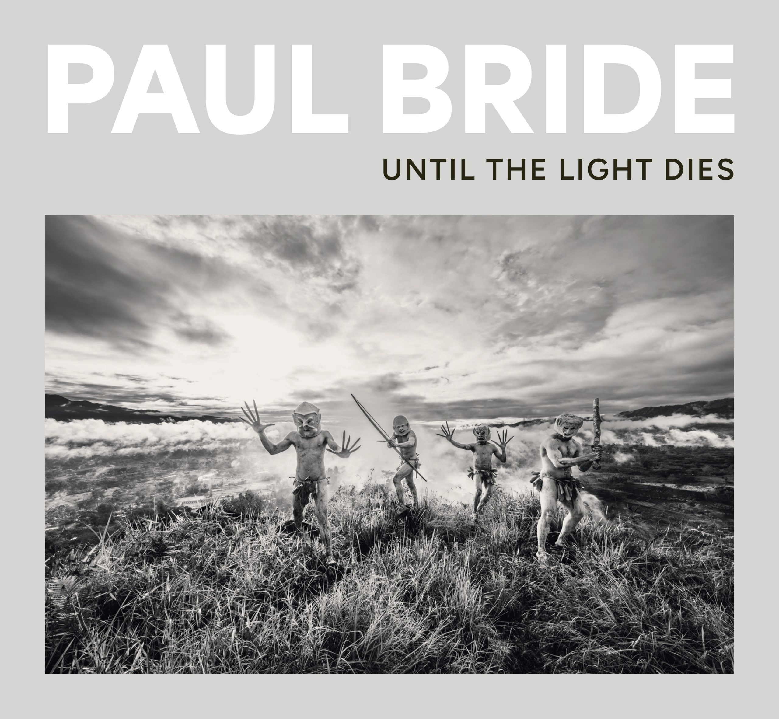 Paul Bride's Until the Light Dies book cover with a black-and-white photograph of four people in a grassy landscape.