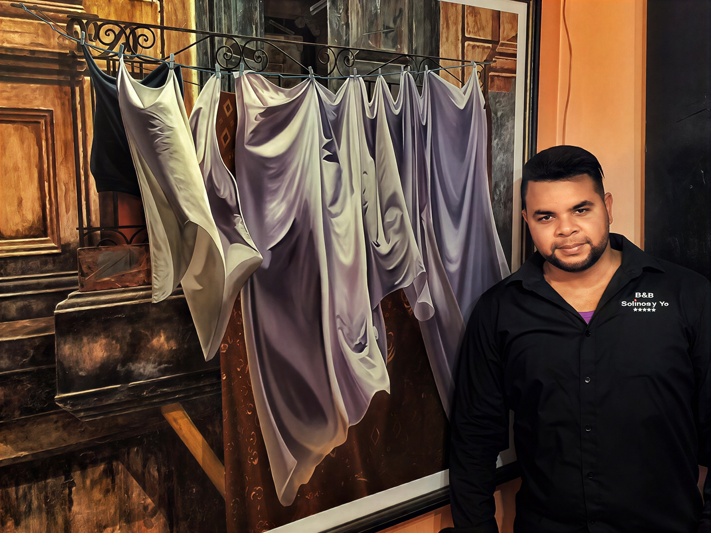 Cuban man standing beside a large painting displayed in an interior.