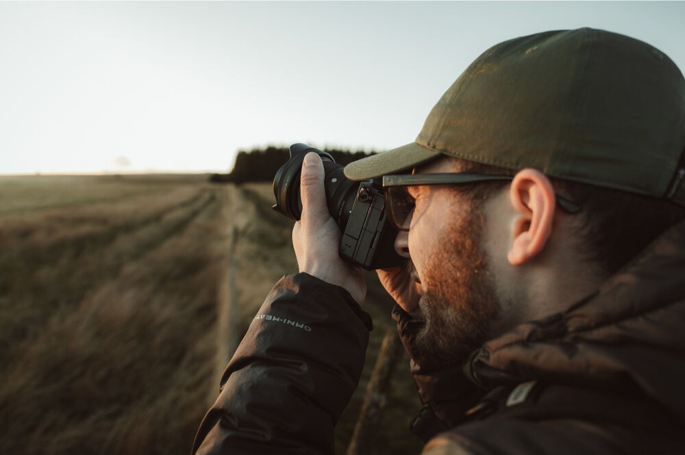 Photographer using the Sigma 20-60mm F2.8-4 DG Contemporary lens outdoors