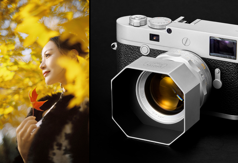Woman holding a leaf beside a Shoten lens on a camera