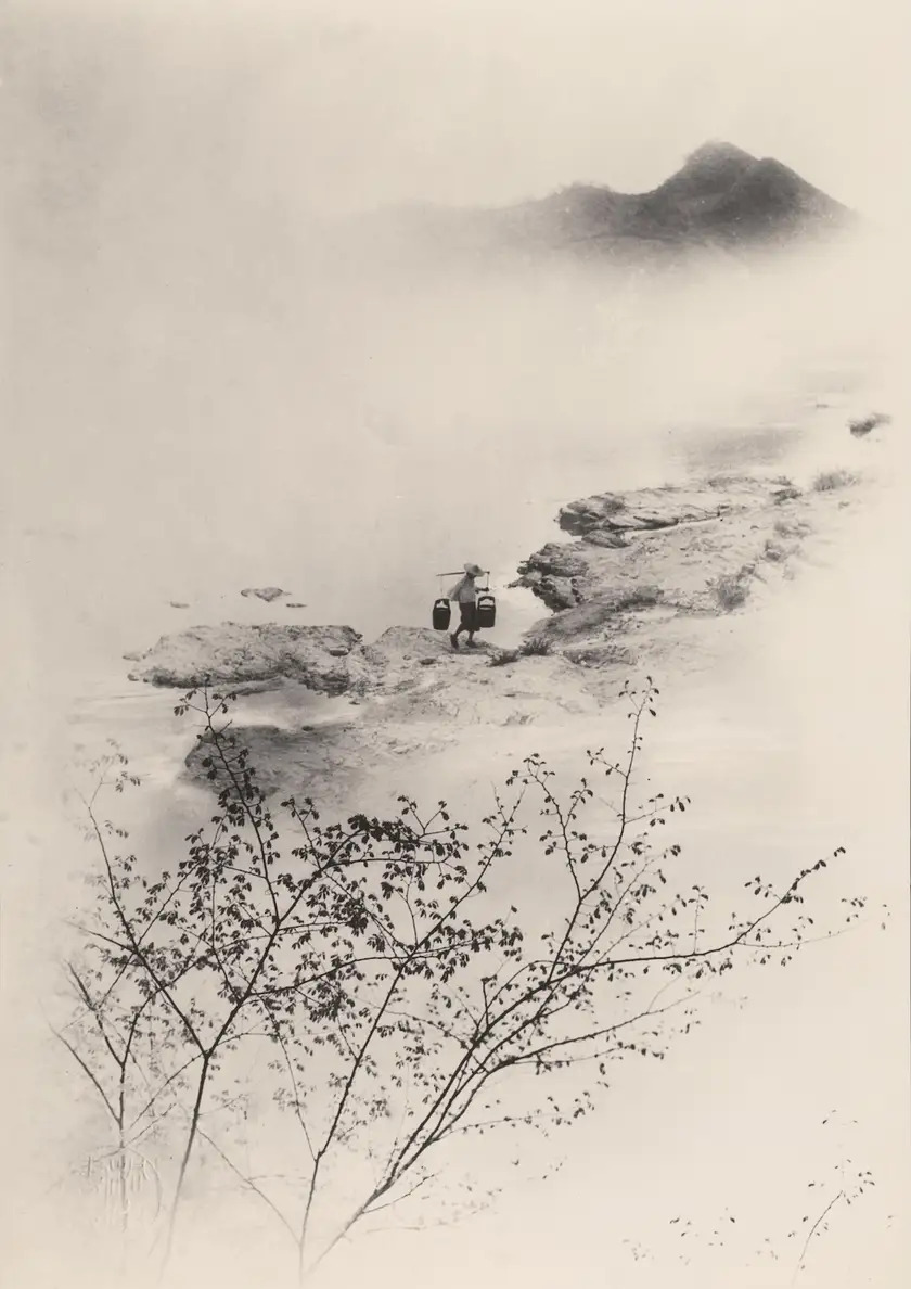Misty landscape with a lone figure on a rocky riverbank in Lang Jingshan's Riverside Spring, 1942