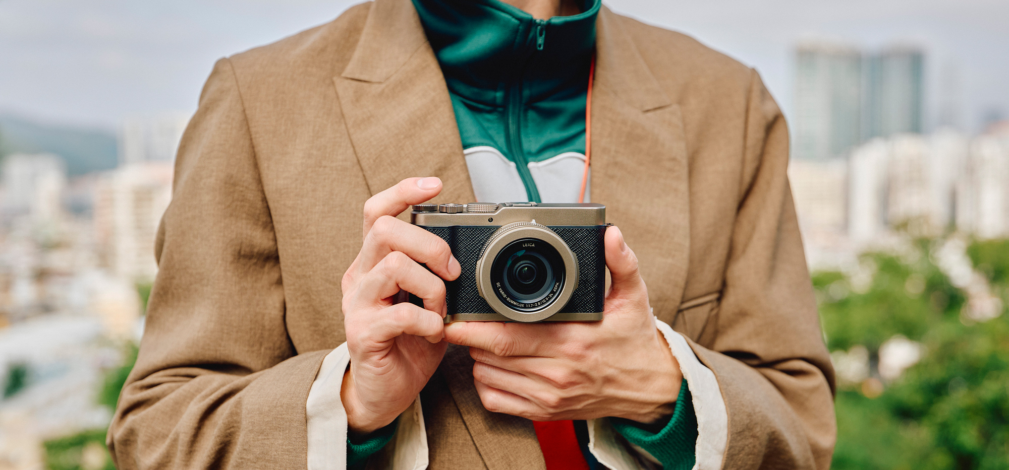 Person holding a Panasonic Lumix DC-L10 camera outdoors