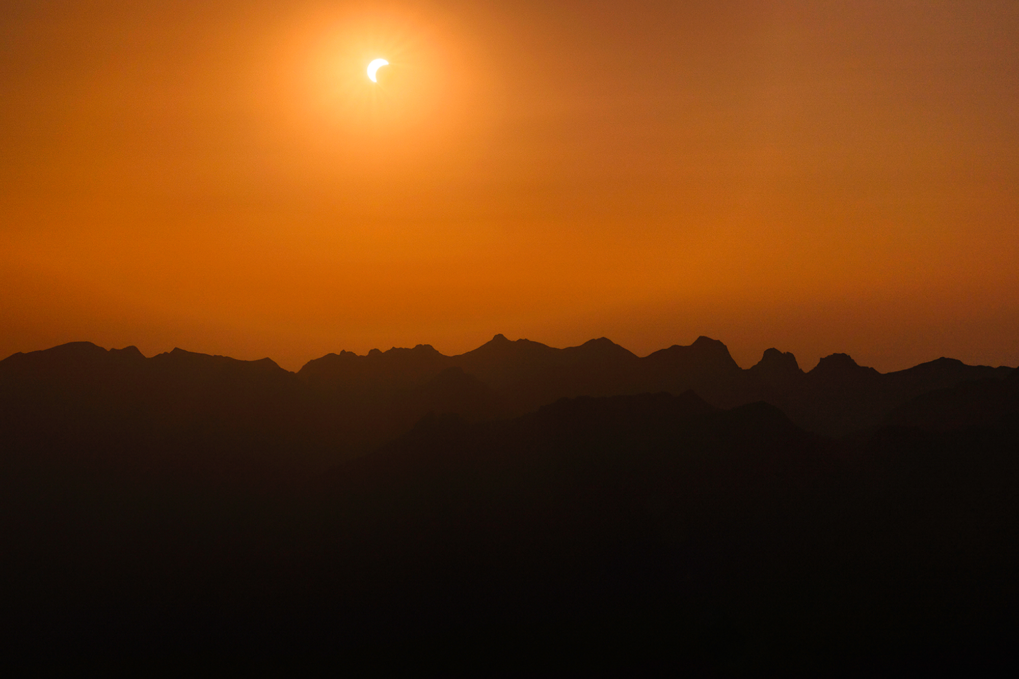 Partial solar eclipse above the Swiss Alps