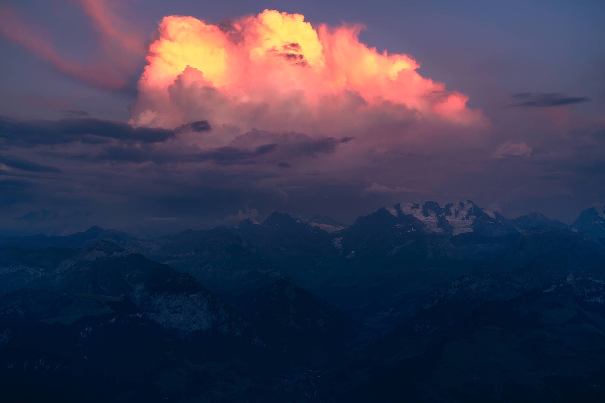 Orange and pink storm clouds over the Swiss Alps