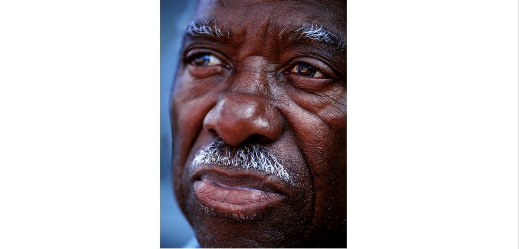 Close-up portrait of Tuskegee Airman Allie C. Peek by Stephen Wilkes, highlighting his expressive eyes and features.