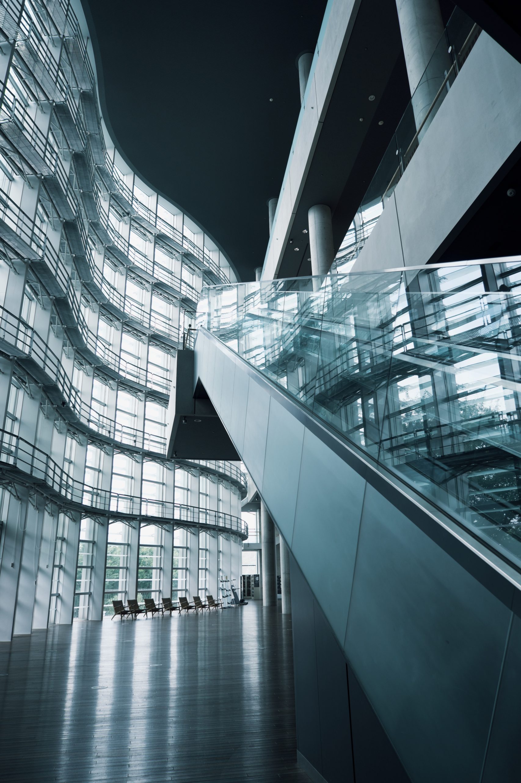 Modern glass-and-steel architectural interior photographed with wide-angle framing.