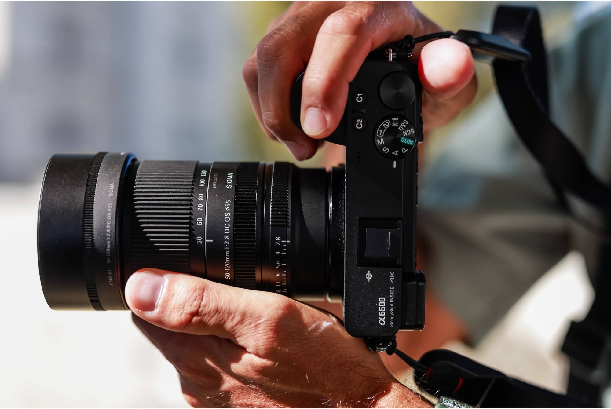 Photographer using a mirrorless camera with a Sigma 50-120mm F2.8 lens