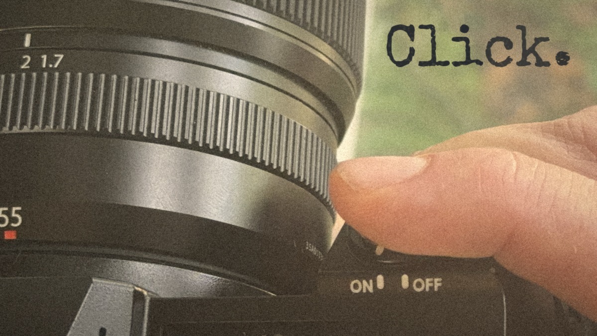 Camera lens with a hand turning the control and the word Click
