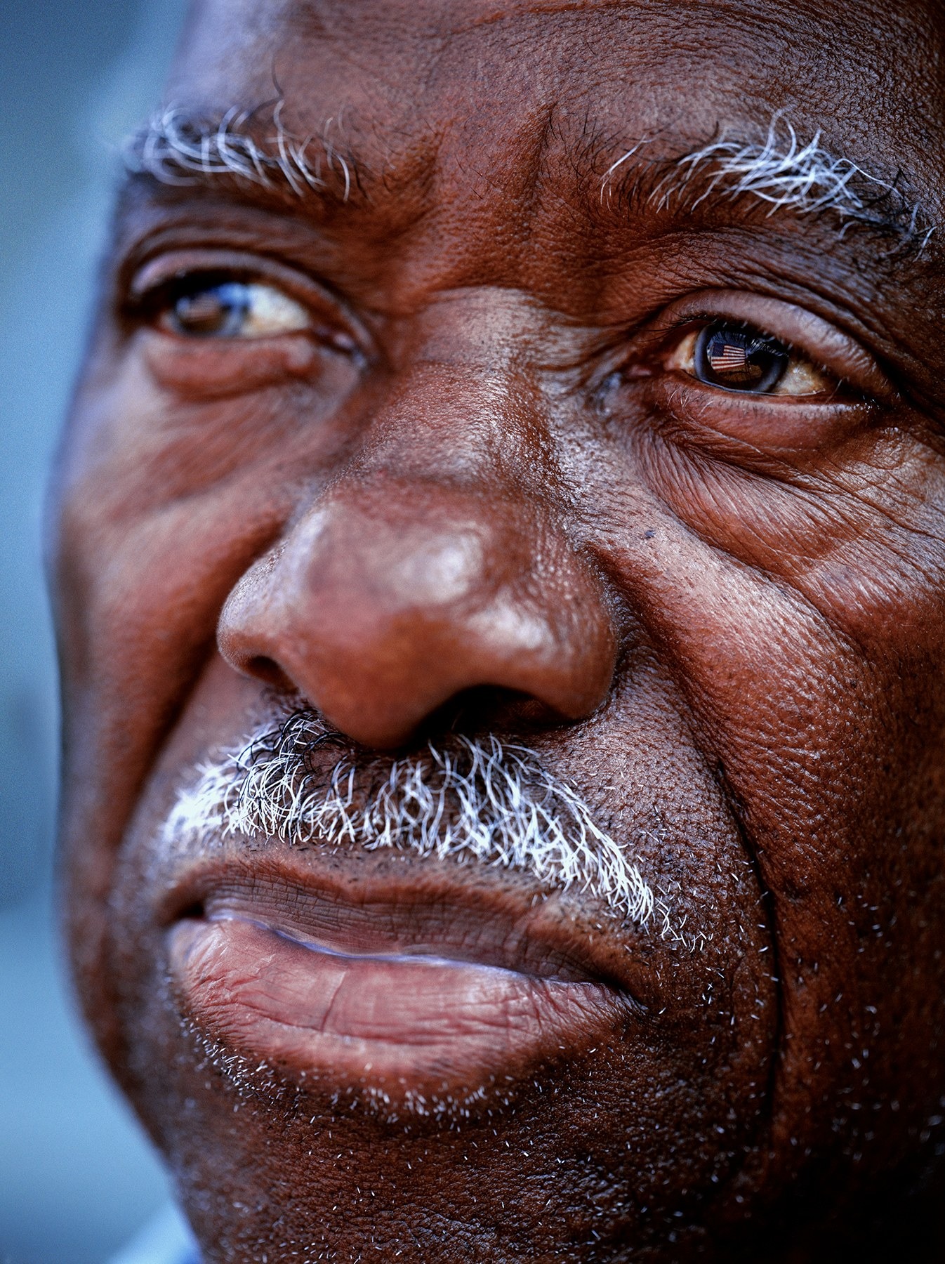 Close-up portrait of Tuskegee Airman Allie C. Peek by Stephen Wilkes, highlighting his expressive eyes and features.