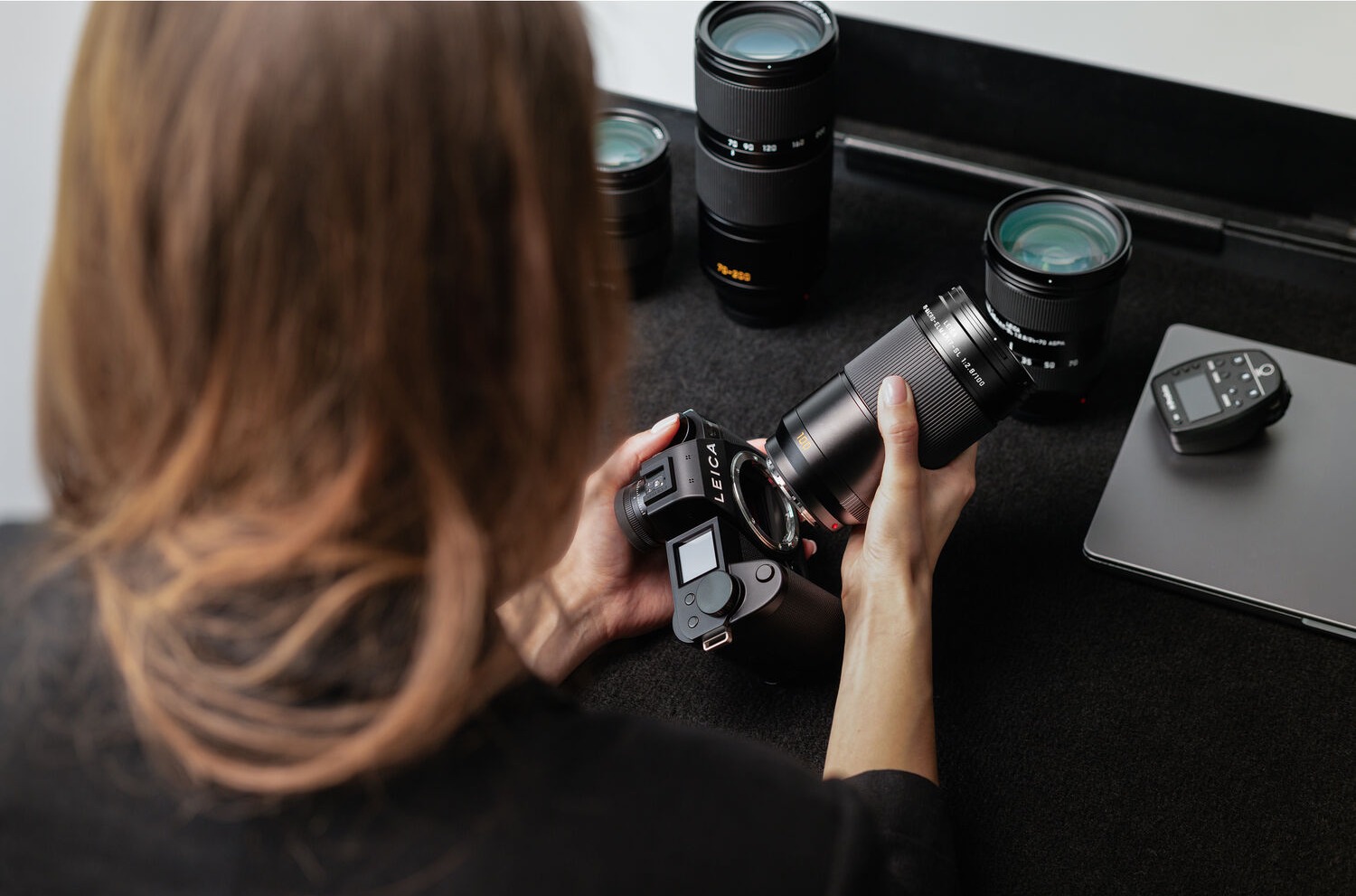 Photographer using a Leica camera with the APO-Macro-Elmarit-SL 100 f/2.8 lens